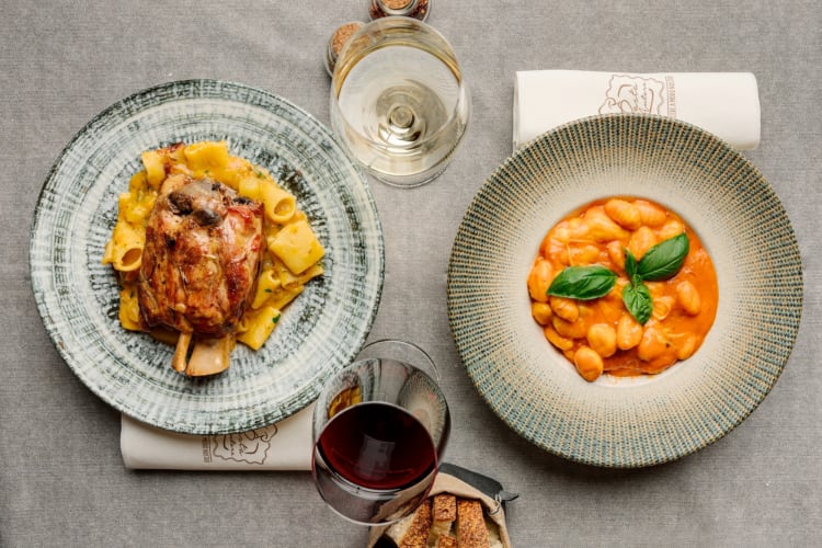 Two pasta dishes on a dining table