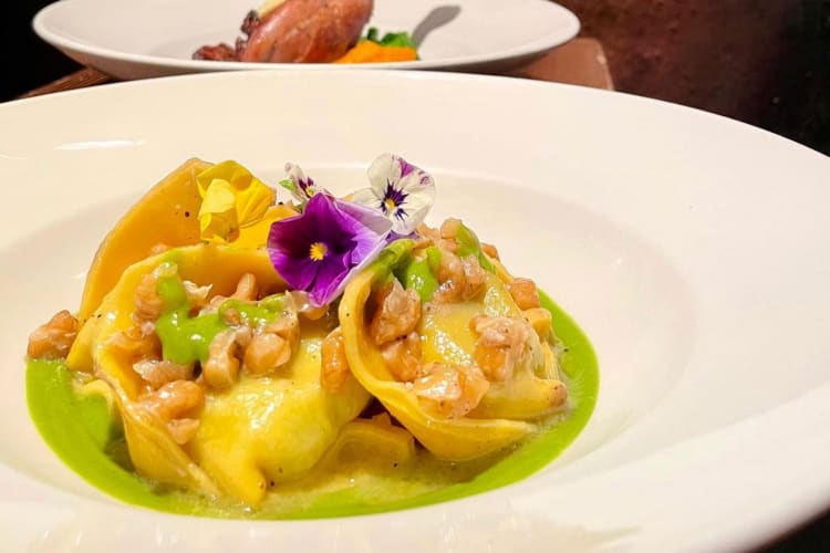 Stuffed pasta with walnuts and edible flowers