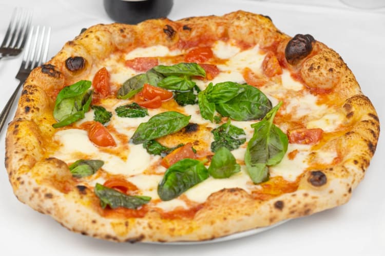 A Margherita pizza with lots of fresh basil