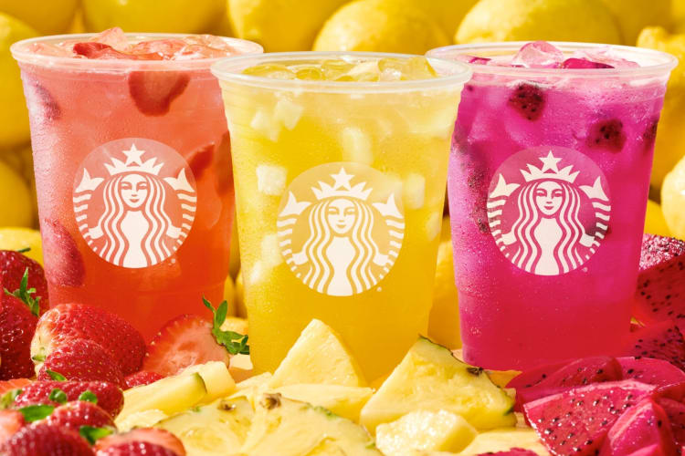 Three fruity Starbucks Refresher drinks and fresh fruit