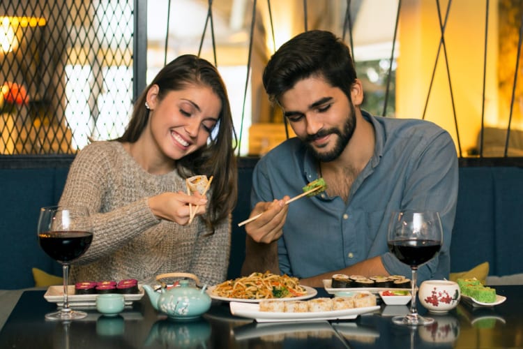A couple eating sushi in a restaurant