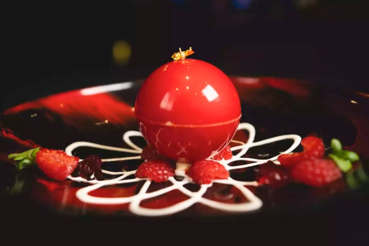 A red chocolate dessert with berries