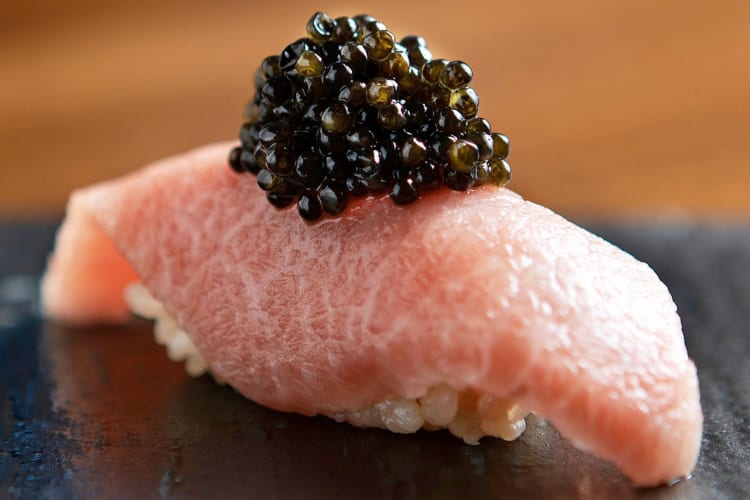 A piece of bluefin nigiri with caviar