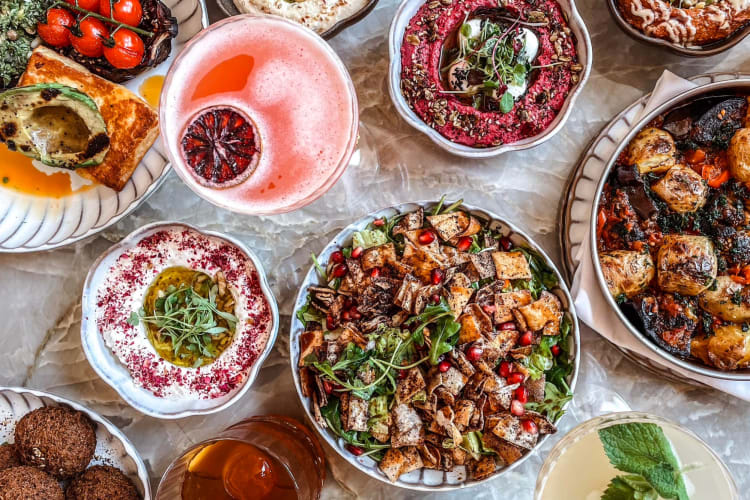 An aerial view of dishes and cocktails on a table 