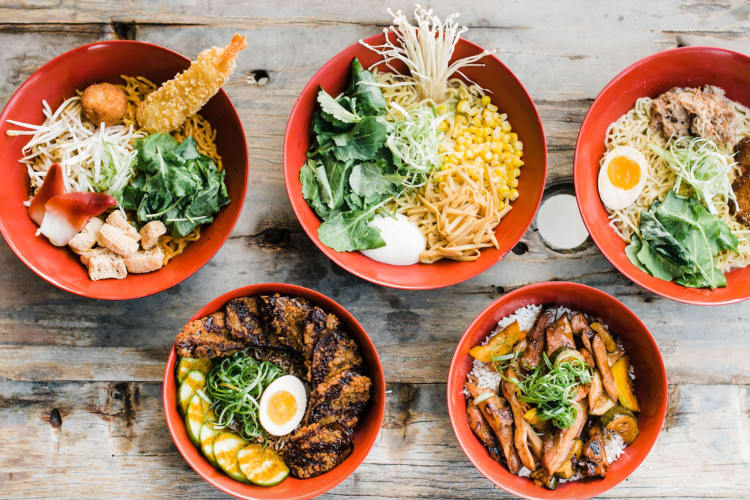 An aerial view of bowls of ramen on a wooden table