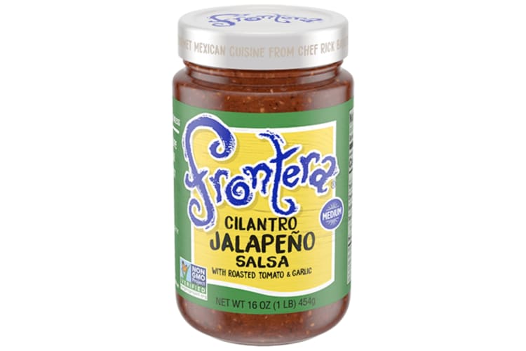 A glass jar of Frontera Cilantro Jalapeño Salsa