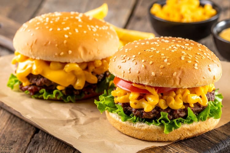 Two burgers with mac and cheese filling