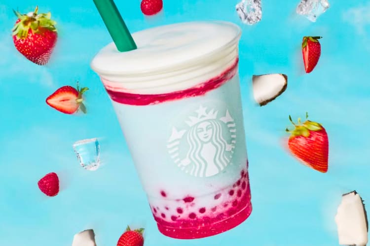 A blue Frappuccino with boba on a blue background with fruits