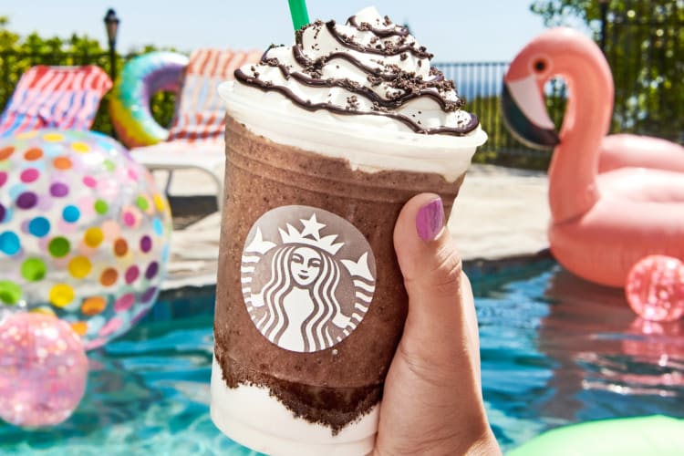 A person holding a Mocha Cookie Crumble Frappuccino 