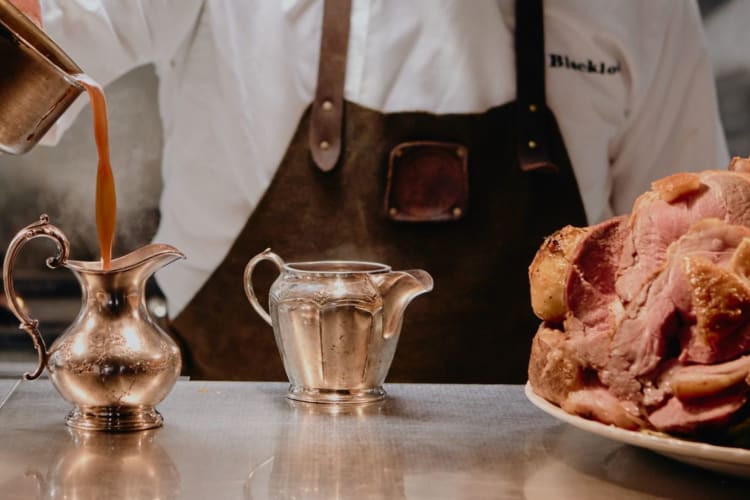 A chef pours gravy into a jug at London's Blacklock.