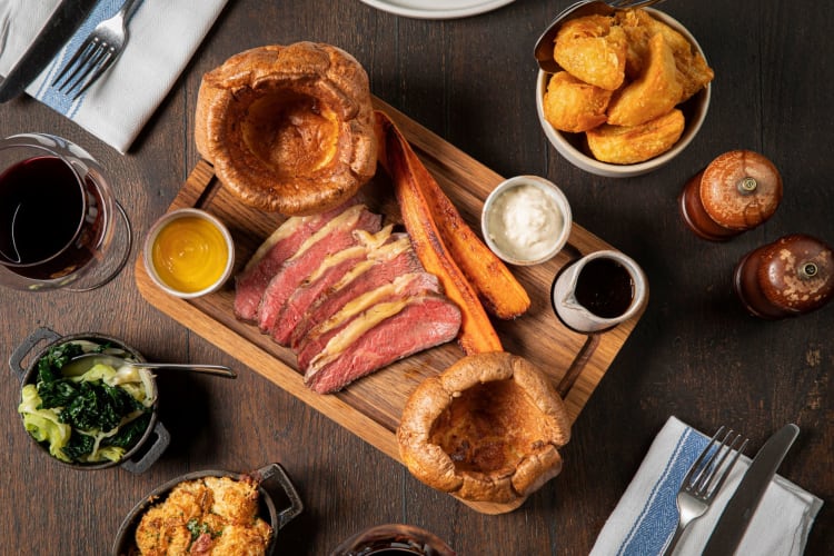 Roasted beef with Yorkshire puddings and roasted vegetables.