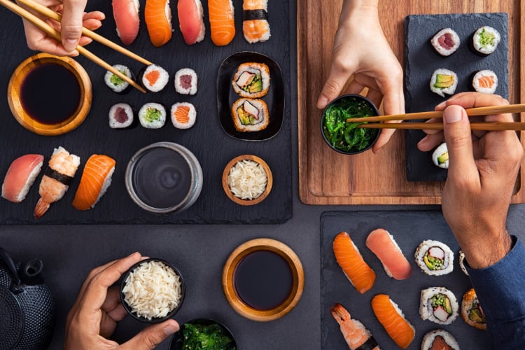 Two people eating sushi 