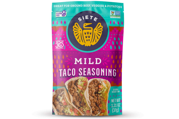 A pink and purple packet of Siete Mild Taco Seasoning