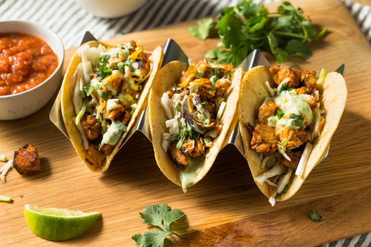 Chicken tacos and a small bowl of salsa