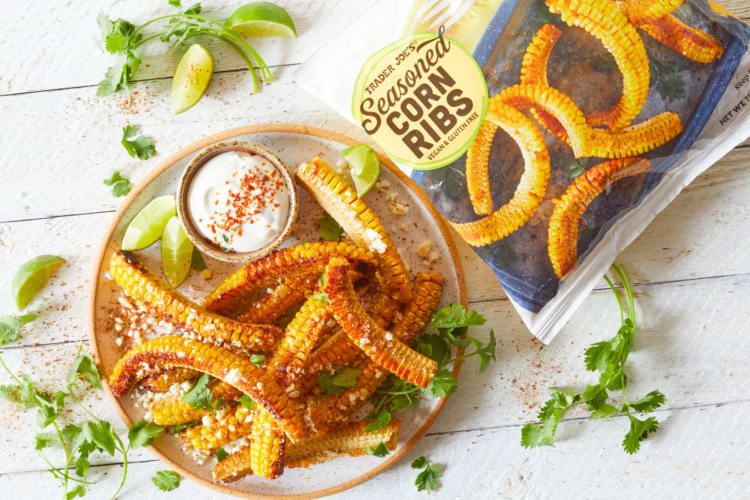 Corn ribs on a plate with lime and cilantro