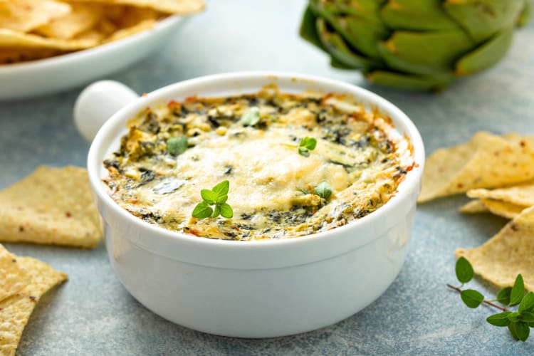 A bowl of spinich and artichoke dip