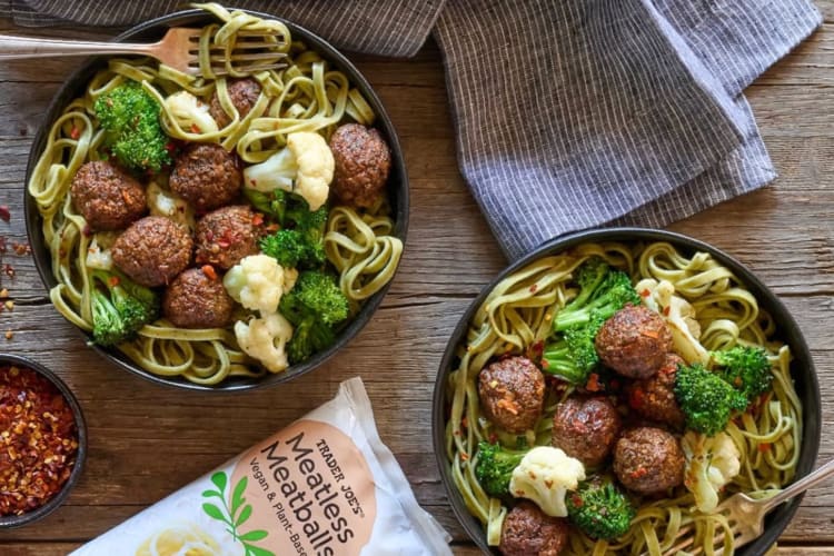 Two bowls of pasta, vegetables and plant-based meatballs