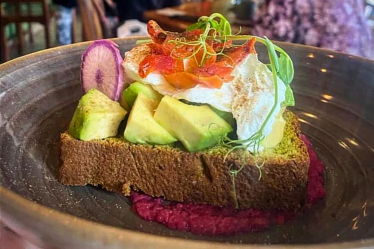 A slice of breakfast toast with toppings.