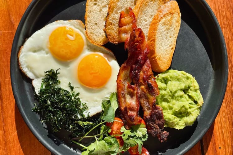 Eggs, bacon and toast on a restaurant table.