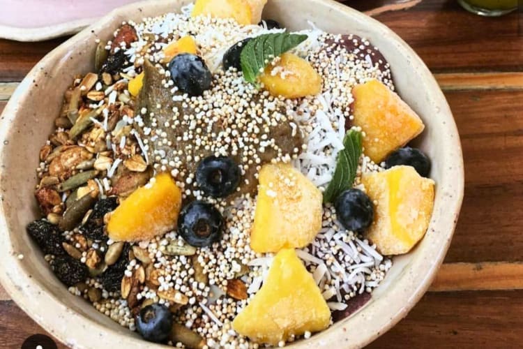 An açaí bowl topped with fruit and nuts.