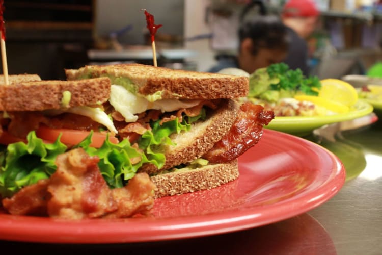 A BLT sandwich on a red plate at Jimmy's Café.