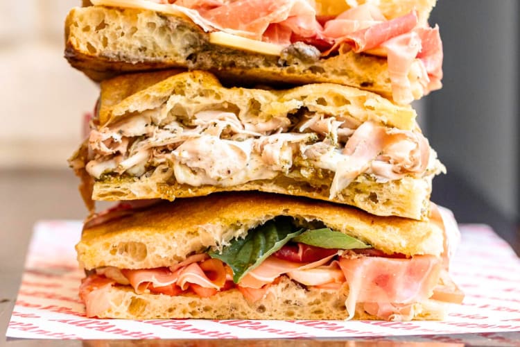 Deli sandwiches stacked on top of each other