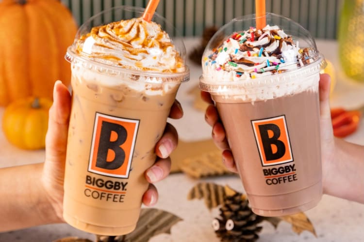 Two iced coffee drinks with whipped cream