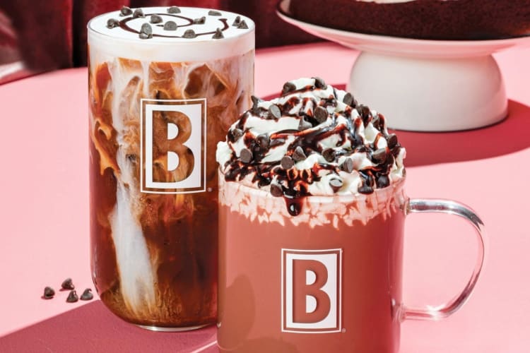 A pink latte drink and coffee drink with cold foam