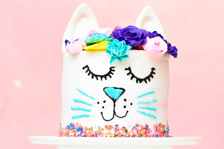 A cake decorated like a cat with flowers
