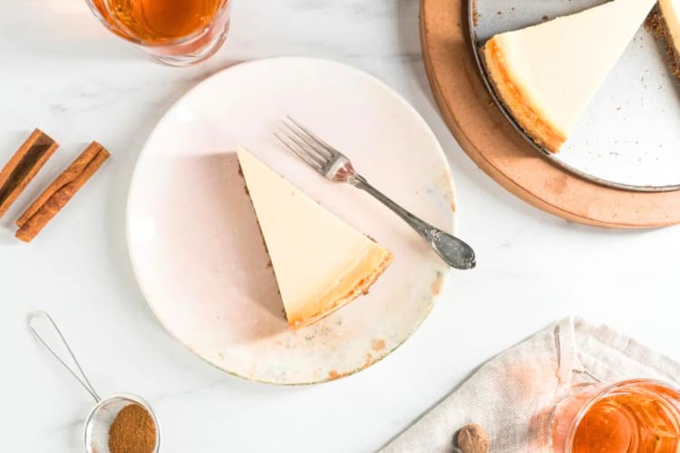 A slice of cheesecake surrounded by ingredients