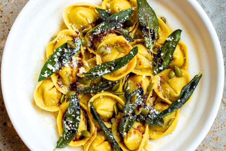 A bowl of ravioli with sage