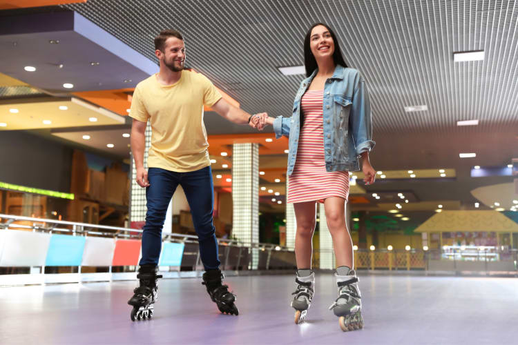 A couple skating at a roller rink