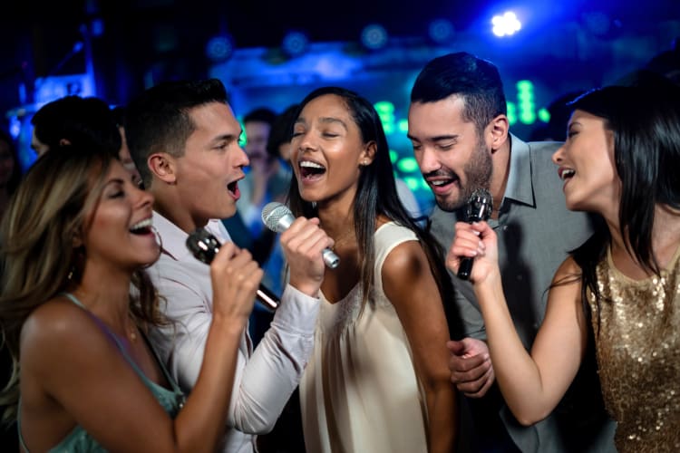 A group of people singining karaoke