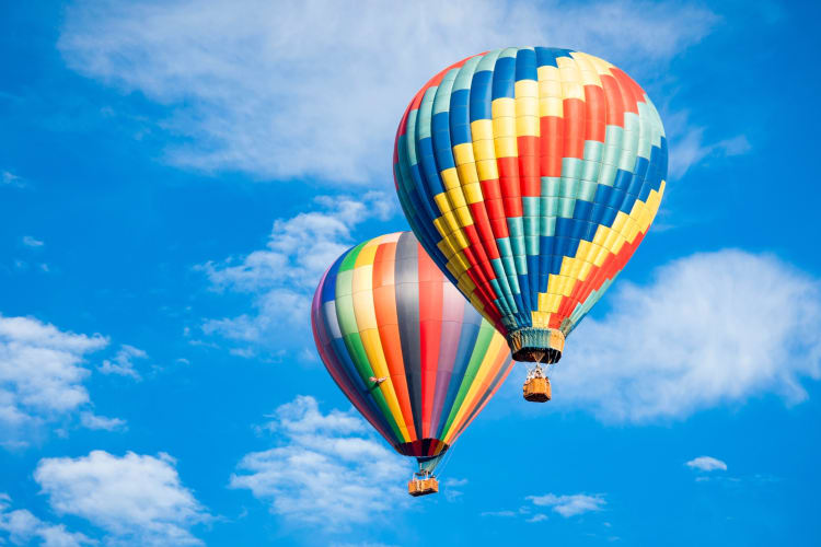 Two colorful hot air balloons in the sky