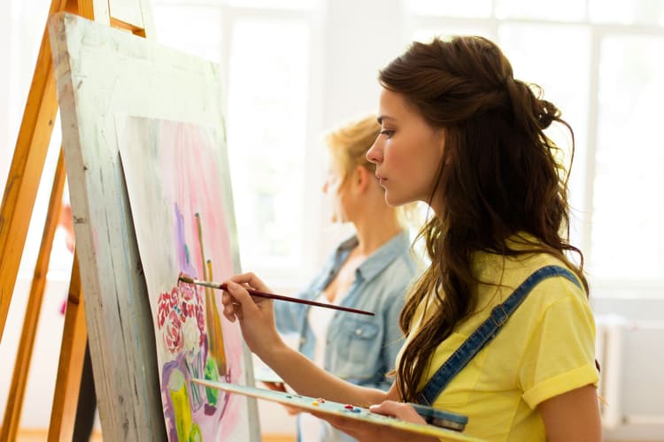 A woman painting on a canvas