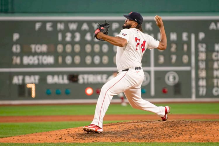 A Boston Red Sox baseball playing pitching