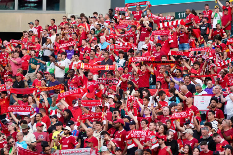 Football fans in red in the stands at a stadium