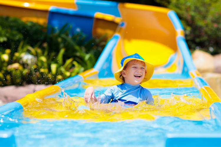 A child on an outdoor waterslide