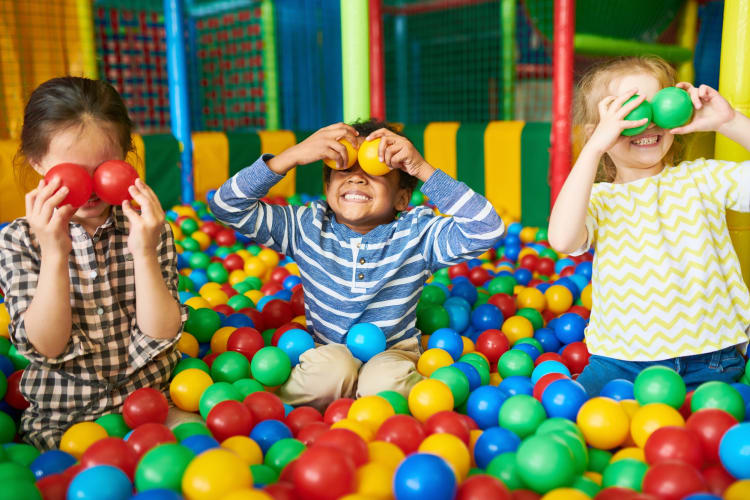 Three kids in a ball pit
