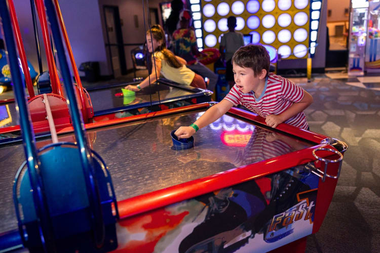 Kids playing air hockey