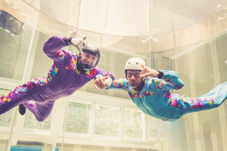 Two people indoor skydiving 