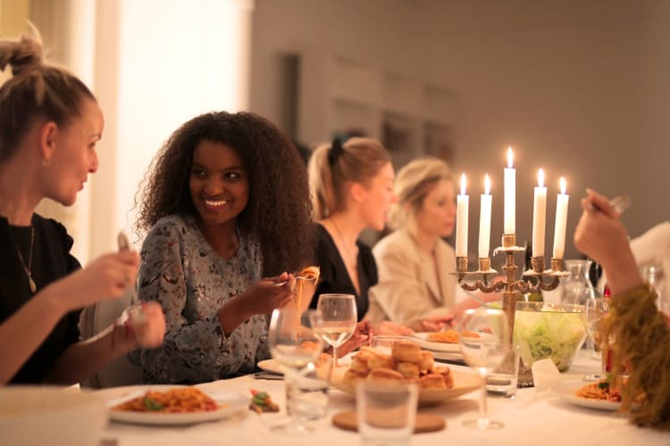 People eating at a table with a candelabra