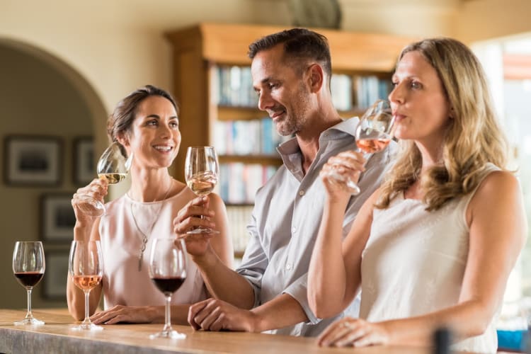 Three people doing a wine tasting