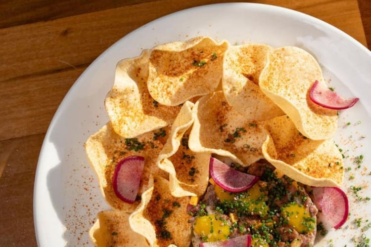 A plate with steak tartare and purple radish 