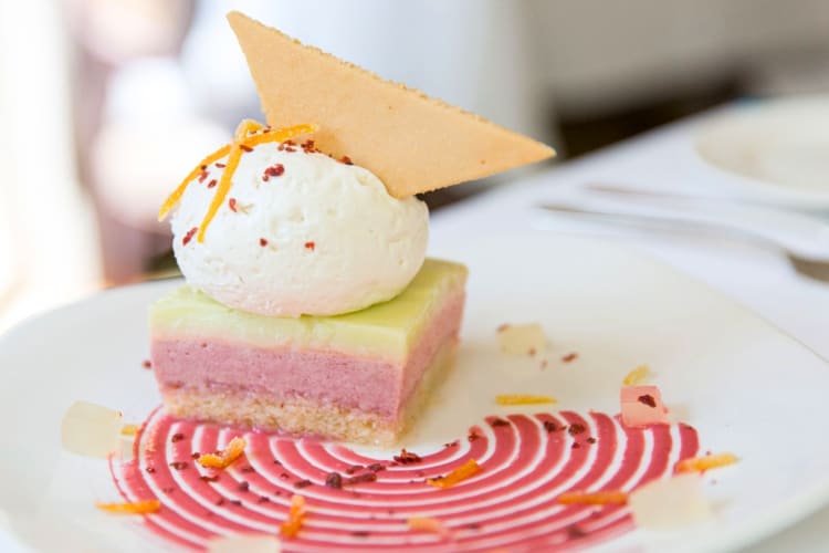 A pink and green dessert on a plate