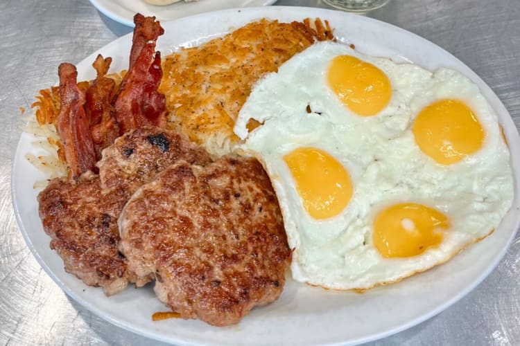 Breakfast meal with eggs, sausage, bacon and cheese from Bisbee Breakfast Club