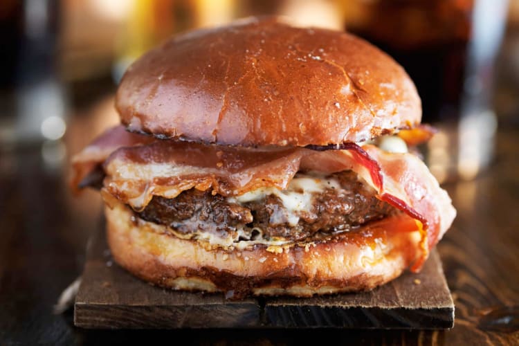 A burger with bacon in a brioche bun