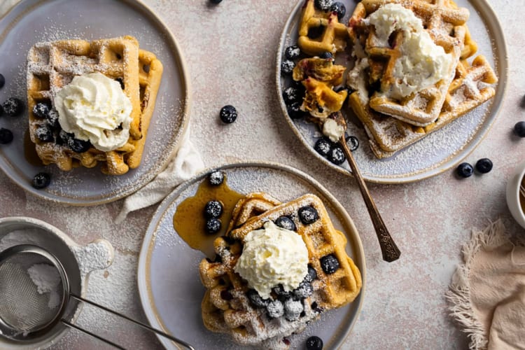 Aerial view of three plates of blueberry waffles, as a breakfast food idea