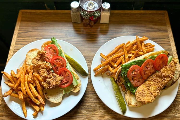 Aerial view of two po' boy meals with fries on the side