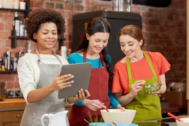 Three friends taking an online baking class as an adult birthday party idea